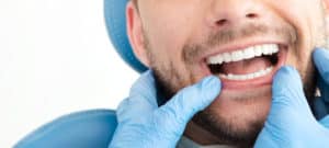 Man having teeth examined